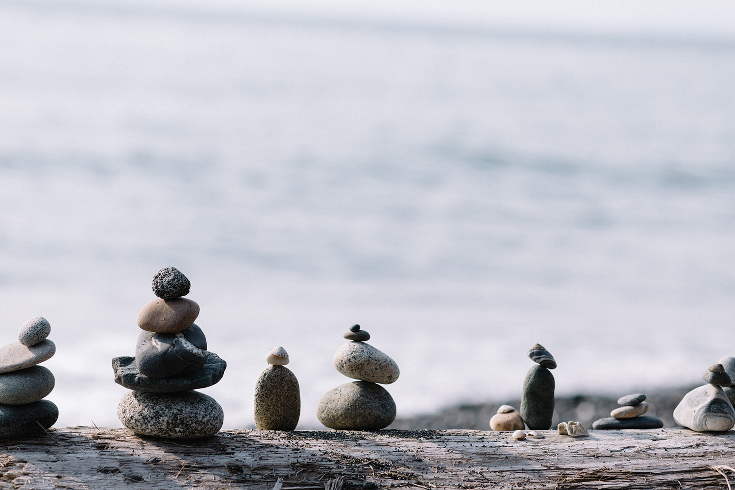 Weighted Blanket Balanced Wellbeing Stones On Top of Each Other in front of Sea